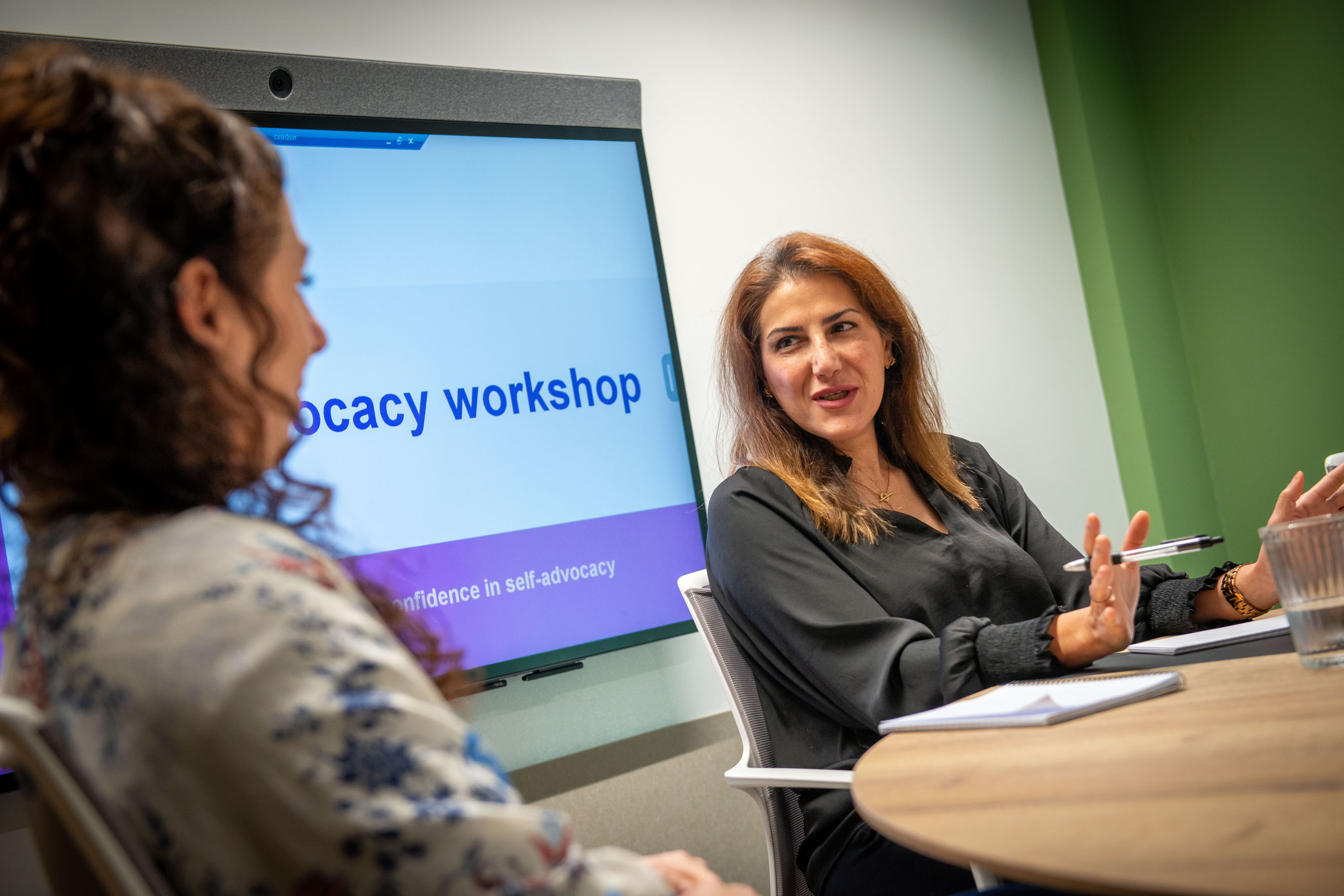 Two members of Connected Voice's Advocacy team in a meeting