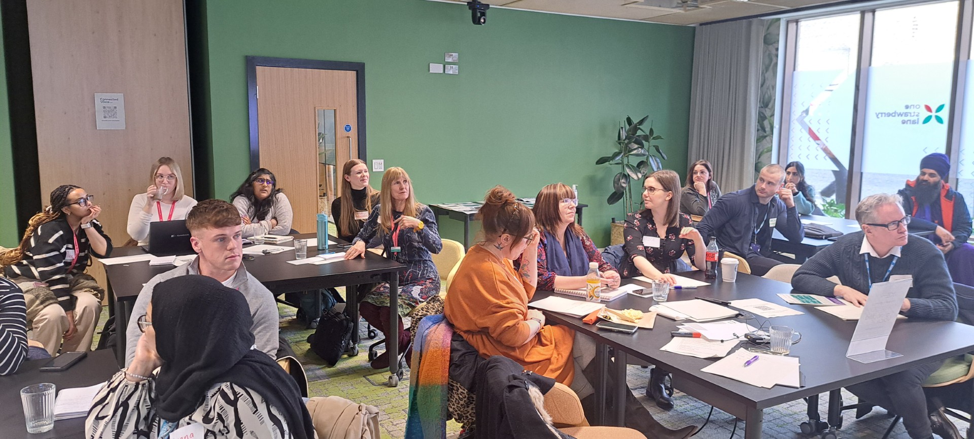 People sat around tables talking