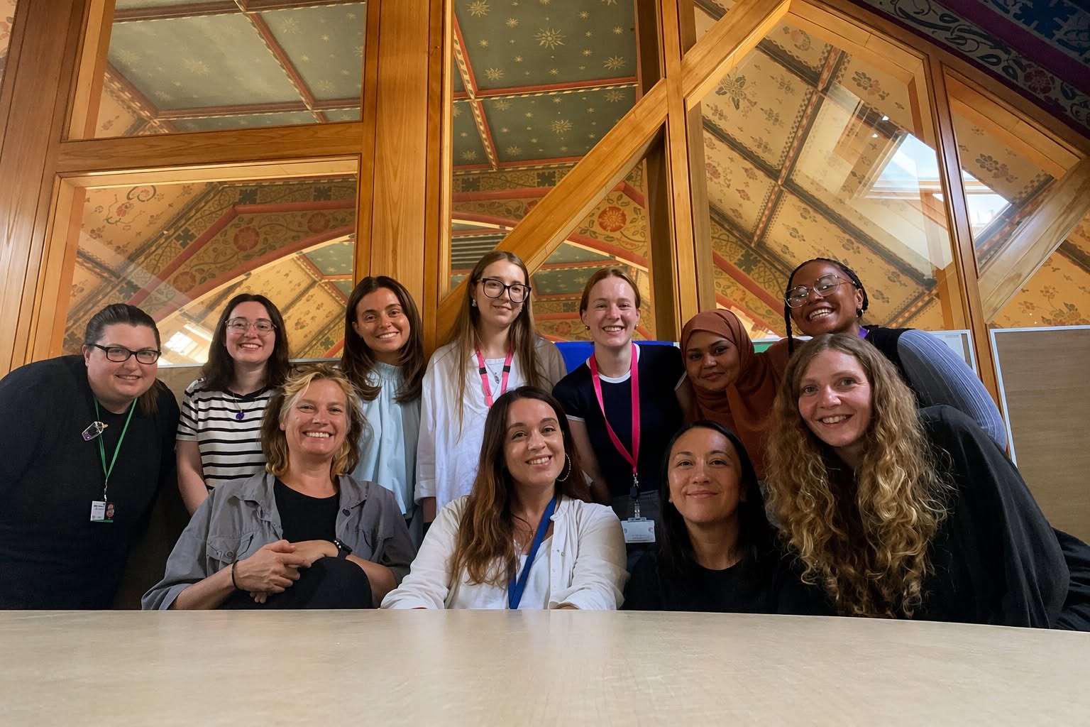 A group of women gathered at a table, smiling