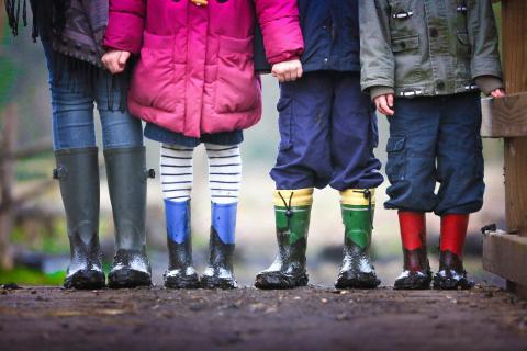 Four sets of children's legs with wellington boots etc.